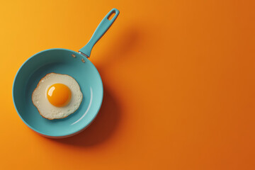 Cooking a sunny-side-up egg in a blue frying pan on an orange background