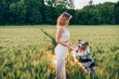 © Cavan Images - vibrant green rye field, capturing the bond between humans and pets