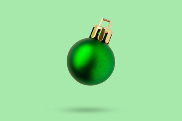 Wall Mural - Green Christmas ball isolated on green background