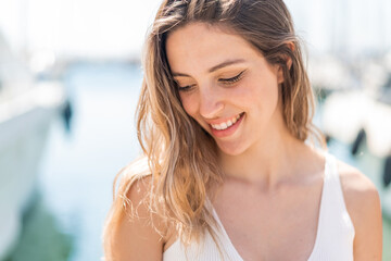 Young pretty woman at outdoors With happy expression