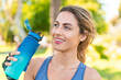 © luismolinero - Young blonde woman at outdoors doing sport with a bottle of water