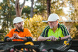 © Austockphoto - Two builders chatting leaning on ute tray