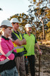 © Austockphoto - Three construction workers standing on worksite with arms crossed