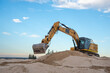 © Austockphoto - Excavator at work digging sand at Dolls Point