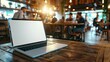 © Lull - Laptop cafe table. Laptop on a wooden table in a cafe, perfect for showcasing your website or app. The blurred background provides a sense of relaxed ambiance.