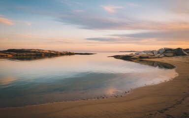 Wall Mural - Peaceful sunset cove. Tranquil scene of a sandy shore meeting calm water with a distant rocky island, bathed in the golden light of sunset.