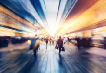 Poster - Blurry photo of people walking through a city street.