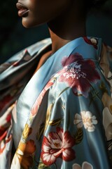 Sticker - Elegant Floral Silk Robe: A close-up of a model wearing a vibrant, floral-patterned robe in soft blue hues, ideal for fashion showcases.