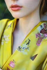 Sticker - Elegant Close-Up of Woman Wearing Yellow Floral Silk Robe, Perfect for Fashion and Lifestyle Themes