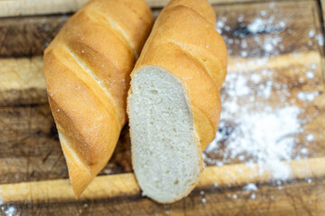 A loaf of sourdough bread on a wooden table, in a cut. a loaf of artisan bread.