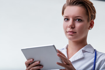 Female doctor using digital tablet with copy space