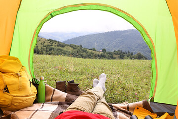 Wall Mural - Woman lying in tent outdoors, closeup view