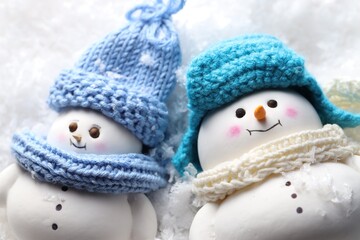 Poster - Cute decorative snowmen on artificial snow, closeup