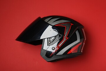 Sticker - Modern motorcycle helmet with visor on red background, top view