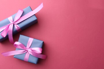 Canvas Print - Beautiful gift boxes with bows on pink background, top view. Space for text