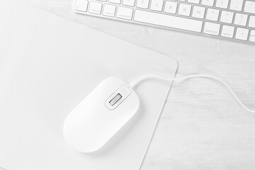 Sticker - Computer mouse with mousepad and keyboard on light wooden table, flat lay