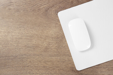 Sticker - Computer mouse with mousepad on wooden table, top view. Space for text