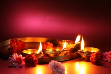 Wall Mural - Diwali celebration. Diya lamps and beautiful flowers on color background, closeup