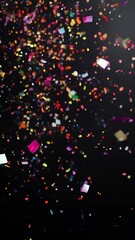 Poster - Colorful confetti falls gracefully on a deep black background, creating a vibrant and festive atmosphere for celebrations