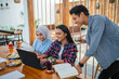 © Odua Images - Group of Asian students studying together on a laptop while enjoying a drink at a coffee shop
