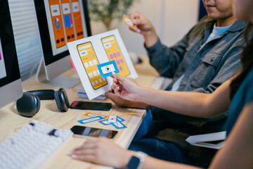 Poster - Two designers are working together to create the best user experience for a mobile application, choosing the right icon for the right action
