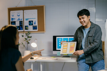 Poster - Two asian ui/ux designers collaborate in a modern office, discussing a mobile app interface
