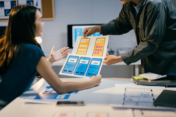 Poster - Two asian professionals working together on user experience, user interface and graphic design for mobile phone application