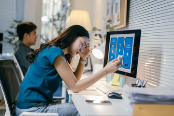 Aufkleber - Exhausted young asian female web developer experiencing difficulties while working on a new project for a mobile application
