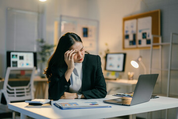 Aufkleber - stressed businesswoman working late in dimly lit office, feeling exhausted and pressured, focused on