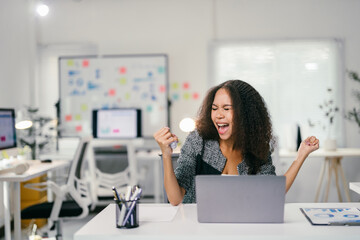 Aufkleber - Excited businesswoman celebrating success in modern office with laptop and documents, proud of her achievement. Bright interior design adds to the atmosphere