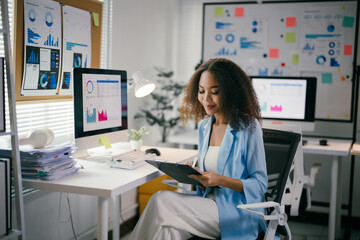 Poster - focused african american businesswoman analyzes financial data in a modern office, exuding confidenc