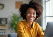 © Tascha - Smiling woman with curly afro hair, wearing a headset, working from home in a cozy office, bright yellow shirt, professional and confident appearance