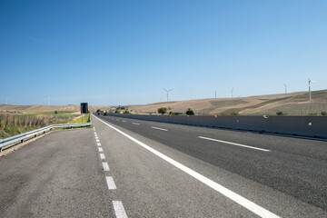 Road through an onshore wind farm in the Puglia region of Italy