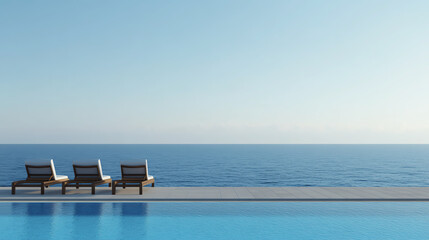 Serene view of a tranquil poolside with three lounge chairs overlooking the calm blue ocean under a clear sky, creating a perfect setting for relaxation and leisure.