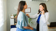 © AntonioDiaz - Woman doctor listens to a female patient's breathing during a medical appointment in her office