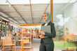 © Odua Images - A confident businesswoman in a stylish hijab stands with her laptop in a chic office