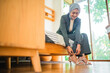 © Odua Images - Muslim woman office worker in hijab wearing shoes getting ready before work in a room