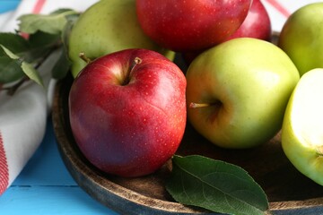 Sticker - Fresh red and green apples on light blue wooden table, closeup