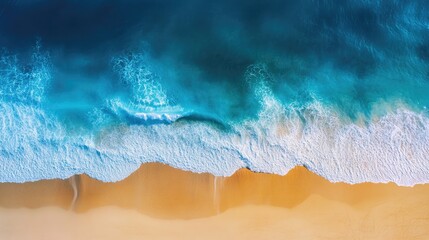 Drone perspective of a sunny coastal scene with azure blue sea, bright waves, and a sandy beach