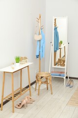 Poster - Clothing rack, mirror, storage bench and clothes in hallway