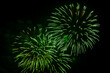 © finist_4 - Green and silver bright sparks of fireworks on the black sky