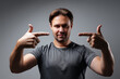 © chaossart - Handsome man pointing fingers on his face studio portrait