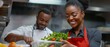 © Karo - Close-up of a beautiful, smiling  woman chef wearing a red apron, taking fresh vegetables from a plastic container in a professional kitchen at a restaurant.