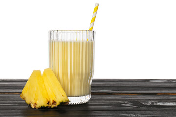 Poster - Tasty pineapple smoothie in glass and slices of fruit on wooden table against white background. Space for text