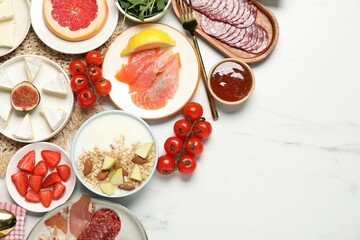 Poster - Different tasty food served for brunch on white marble table, flat lay. Space for text