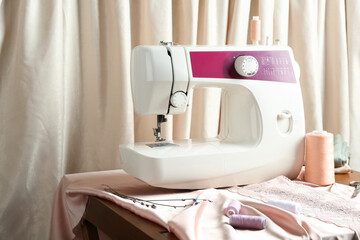 Wall Mural - Sewing machine with fabric and spools on table indoors