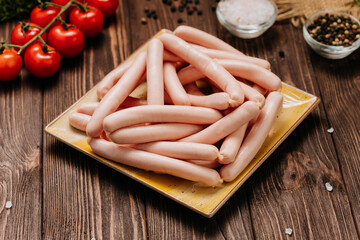 Stack of sausages on plate, ideal for BBQ, grilling, or quick meals, displayed in a kitchen setting