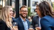 © Pinklife - A lively social gathering outside showing people smiling and holding drinks, illustrating the joy and camaraderie of a casual get-together in a modern setting.