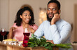 © Prostock-studio - Bad Date. African American Couple Having Unsuccessful Blind Date In Restaurant, Funny Disappointed Shoked Black Man Feeling Embarrassment Listening To Excited Woman Talking