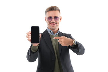 Mature business man presenting phone screen. Businessman man showing phone isolated on white. Pointing finger. Man showing new business phone app. Presenting product. Advertisement of business app